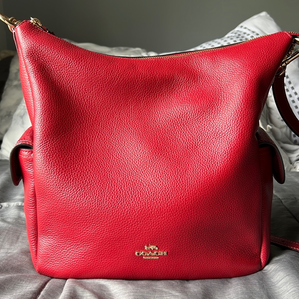 Beautiful red, gold hardware, looks brand new! Can be worn shoulder or crossbody